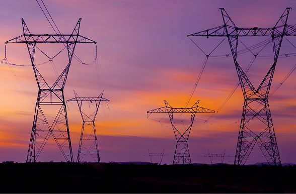 Power lines against a orange and purple sunset.